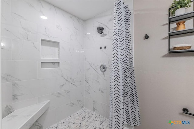 full bath featuring a tile shower