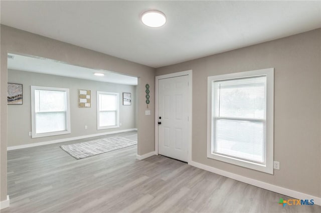 entryway featuring baseboards and light wood-style floors