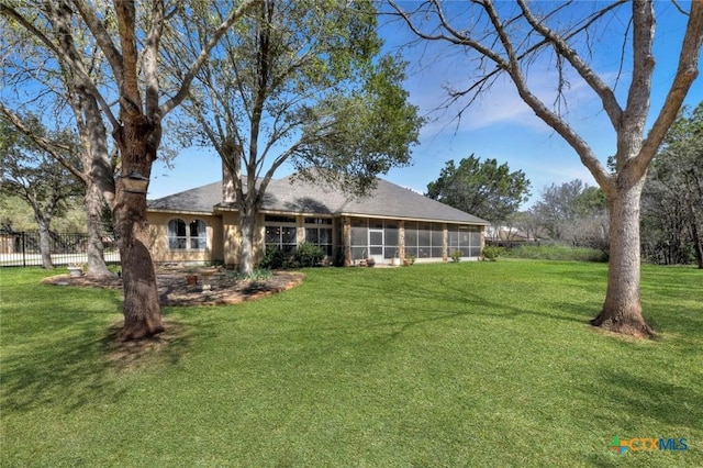 10510 Teich Loop, New Braunfels, TX 78132 - rear view of house with a sunroom, a lawn, and fence