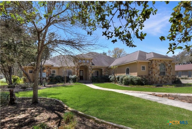 10510 Teich Loop, New Braunfels, TX 78132 - view of front facade with stucco siding, a front yard, and stone siding