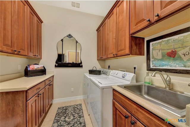 10510 Teich Loop, New Braunfels, TX 78132 - washroom featuring visible vents, cabinet space, a sink, light tile patterned floors, and separate washer and dryer