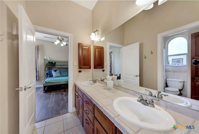 10510 Teich Loop, New Braunfels, TX 78132 - bathroom featuring a sink, ensuite bath, toilet, and double vanity