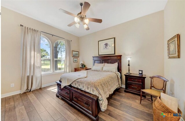 10510 Teich Loop, New Braunfels, TX 78132 - bedroom featuring baseboards, ceiling fan, and hardwood / wood-style floors