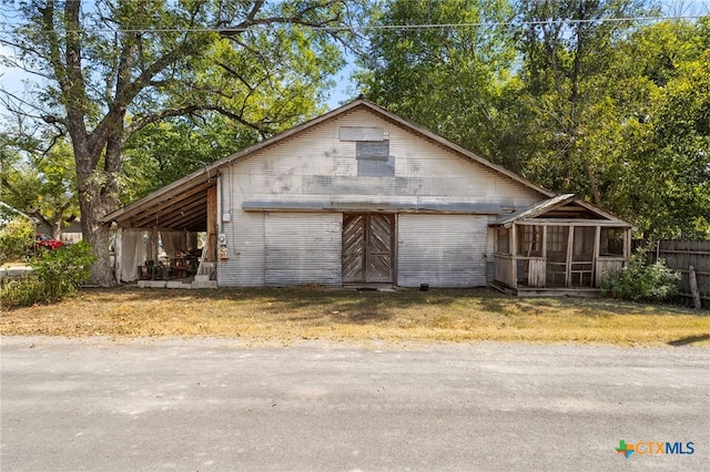 view of outbuilding featuring a sunroom and a carport