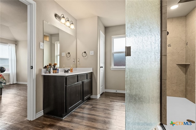 4505 Prewitt Ranch Rd, Killeen, TX 76549 - bathroom featuring vanity, wood finished floors, tiled shower, and healthy amount of natural light