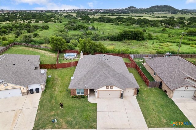 4505 Prewitt Ranch Rd, Killeen, TX 76549 - ranch-style home with a garage, driveway, brick siding, and a shingled roof