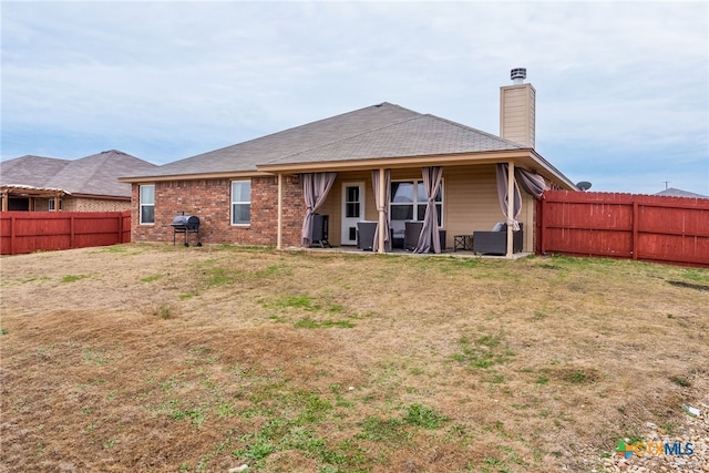 4505 Prewitt Ranch Rd, Killeen, TX 76549 - rear view of house featuring a fenced backyard, a chimney, a patio, and brick siding