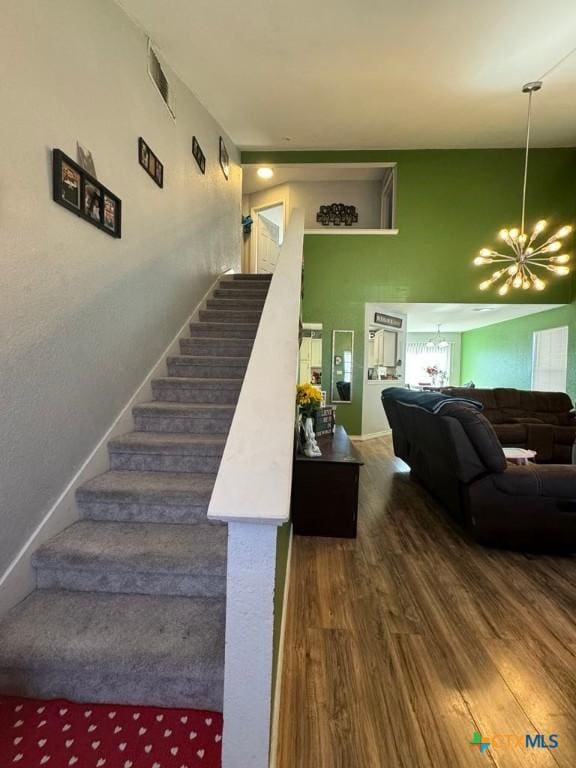 stairway featuring a chandelier and hardwood / wood-style floors