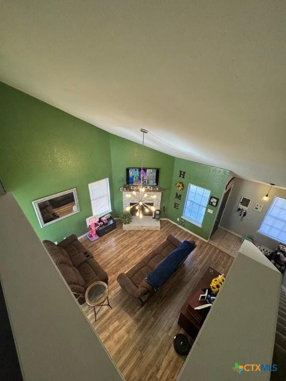 living room featuring wood-type flooring and vaulted ceiling