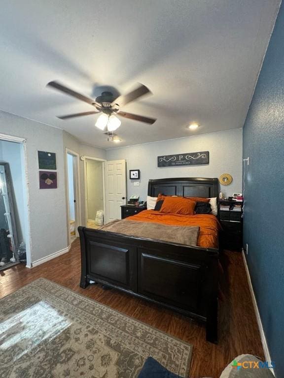 bedroom featuring ceiling fan and dark hardwood / wood-style floors