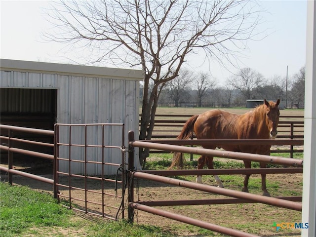 view of horse barn featuring a rural view