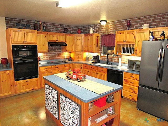 kitchen featuring sink, black appliances, and brick wall