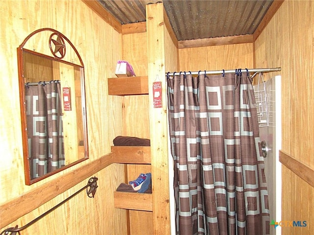 bathroom featuring wooden walls