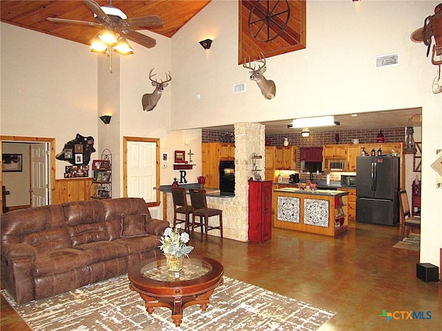 living room featuring wood ceiling and ceiling fan