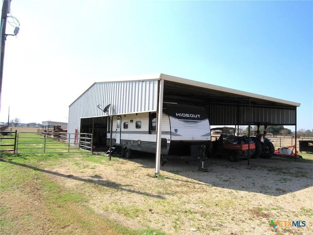 view of outdoor structure featuring an outbuilding and a carport
