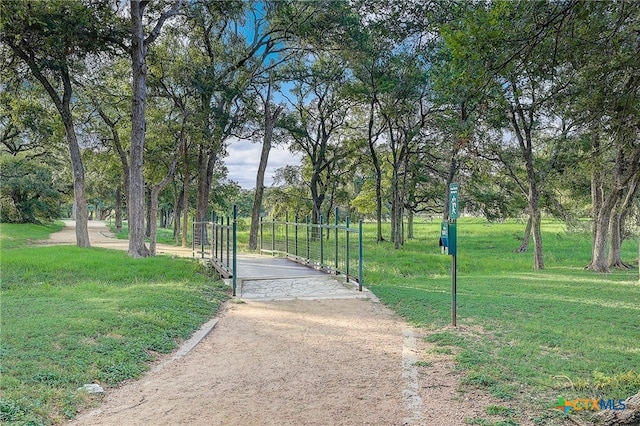 view of home's community featuring a gate and a lawn