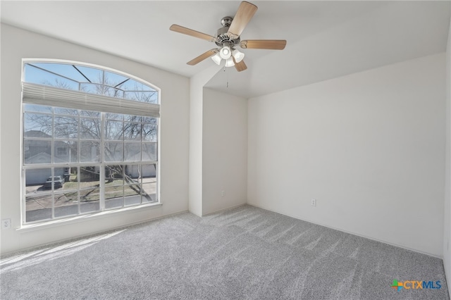 unfurnished room with carpet flooring and ceiling fan