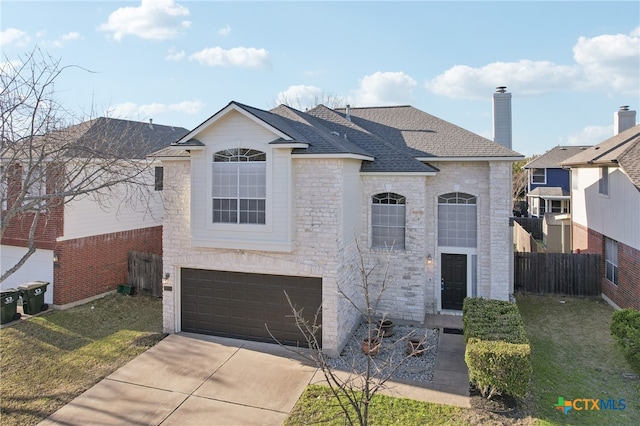 view of front of house with fence, roof with shingles, concrete driveway, a front yard, and an attached garage