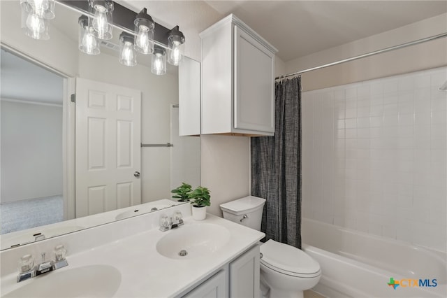 bathroom featuring double vanity, toilet, shower / tub combo with curtain, and a sink