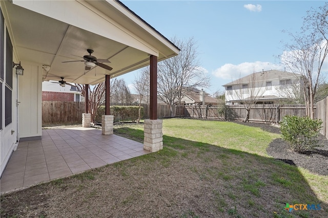 view of yard with a fenced backyard, a ceiling fan, and a patio area