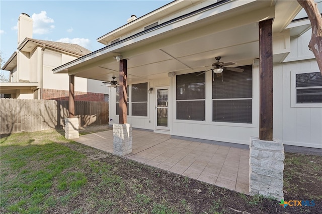 view of patio featuring ceiling fan and fence