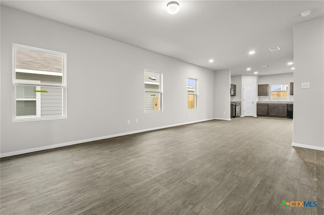 unfurnished living room featuring dark wood-type flooring