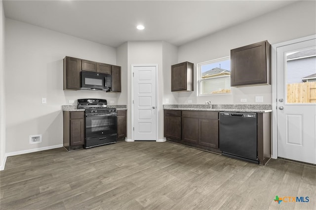 124 Linnet Ln, Maxwell, TX 78656 - kitchen featuring black appliances, dark brown cabinetry, wood finished floors, and recessed lighting