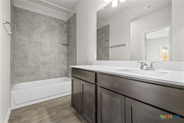 124 Linnet Ln, Maxwell, TX 78656 - full bathroom featuring  shower combination, wood finished floors, and vanity
