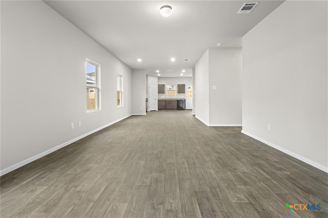 124 Linnet Ln, Maxwell, TX 78656 - unfurnished living room with dark wood finished floors and recessed lighting