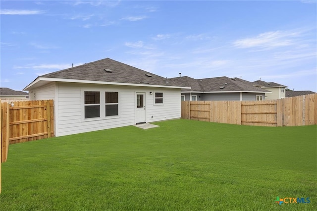 124 Linnet Ln, Maxwell, TX 78656 - back of property with a fenced backyard and a shingled roof