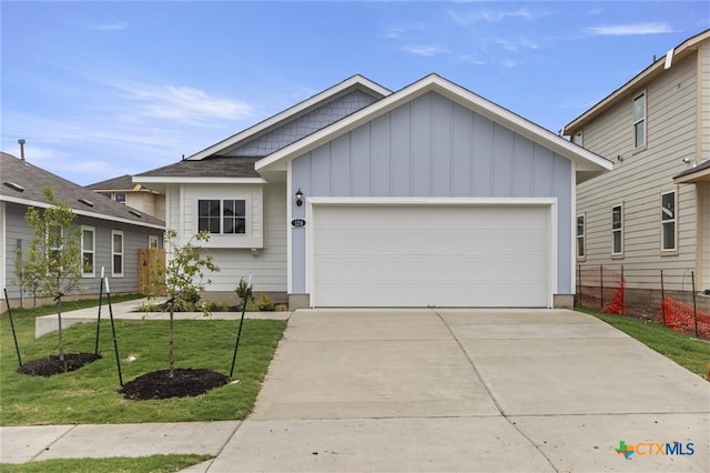 view of front of house with a garage and a front lawn