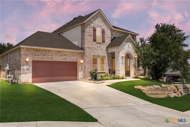 29121 Ismorada, San Antonio, TX 78260 - french country home featuring a front yard, driveway, a garage, and brick siding