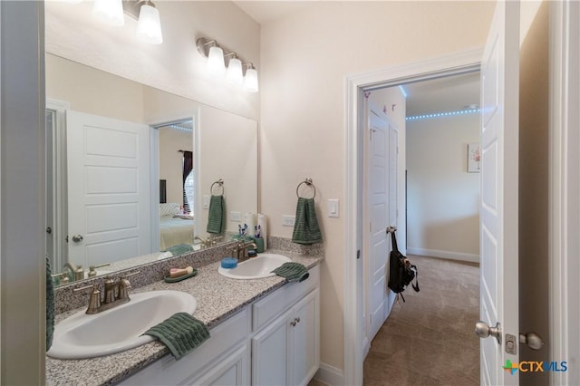 29121 Ismorada, San Antonio, TX 78260 - full bathroom with double vanity, connected bathroom, and baseboards