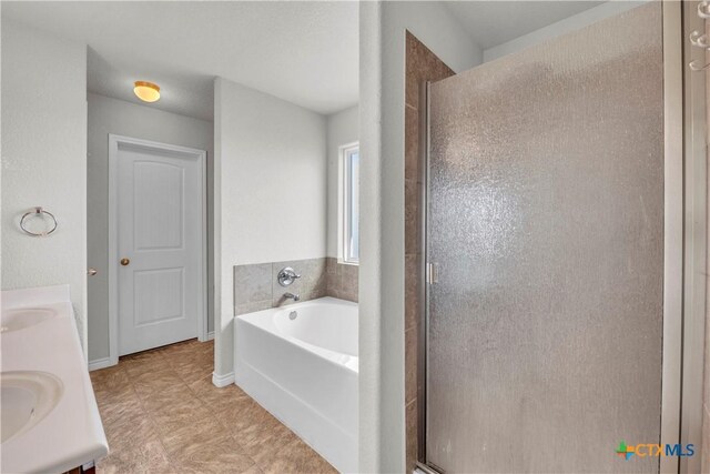 2506 Alamocitos Creek Dr, Killeen, TX 76549 - bathroom featuring a shower stall, a garden tub, double vanity, and baseboards