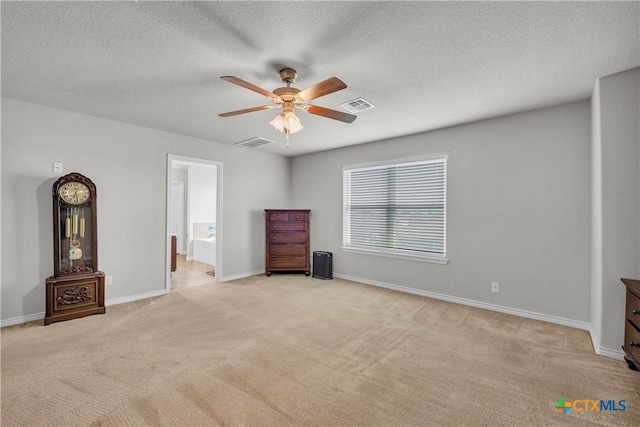 2506 Alamocitos Creek Dr, Killeen, TX 76549 - unfurnished bedroom with light colored carpet, baseboards, a textured ceiling, ceiling fan, and ensuite bathroom