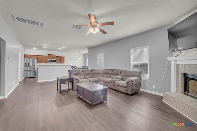 2506 Alamocitos Creek Dr, Killeen, TX 76549 - living area with a ceiling fan, dark wood-style floors, a fireplace, and baseboards