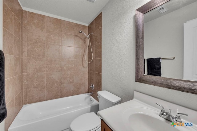 2506 Alamocitos Creek Dr, Killeen, TX 76549 - bathroom with toilet, a textured wall, vanity, and bathtub / shower combination