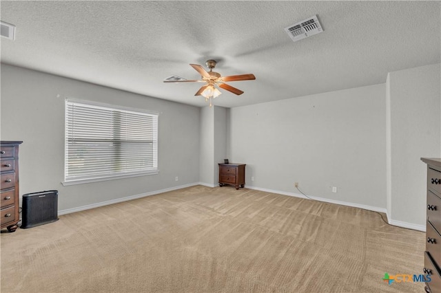 2506 Alamocitos Creek Dr, Killeen, TX 76549 - unfurnished living room featuring a ceiling fan, light colored carpet, baseboards, and a textured ceiling