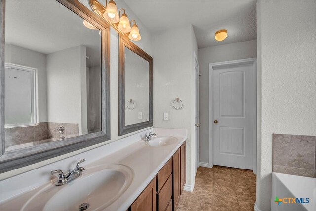 2506 Alamocitos Creek Dr, Killeen, TX 76549 - bathroom featuring a tub, double vanity, and tile patterned flooring