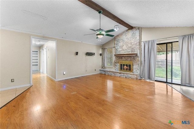 14311 Arrowood, San Antonio, TX 78233 - unfurnished living room with wood finished floors, a ceiling fan, a textured ceiling, and a stone fireplace