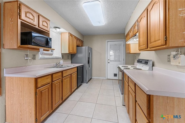 14311 Arrowood, San Antonio, TX 78233 - kitchen featuring black appliances, under cabinet range hood, a textured ceiling, light countertops, and light tile patterned flooring