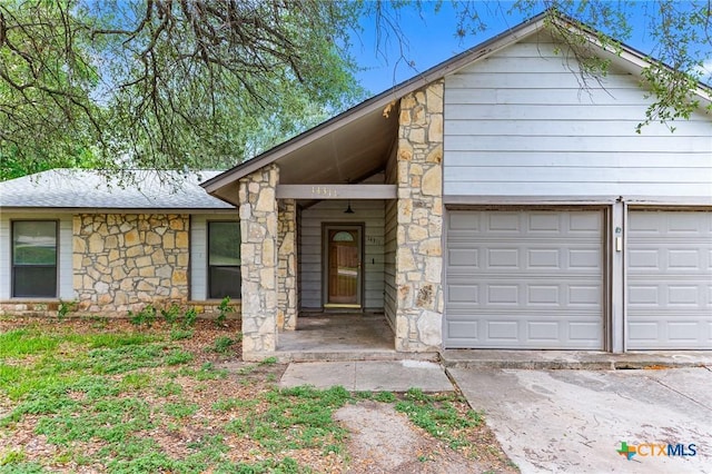 14311 Arrowood, San Antonio, TX 78233 - view of front of property featuring stone siding and a garage