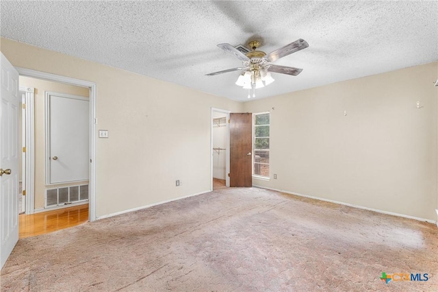 14311 Arrowood, San Antonio, TX 78233 - unfurnished bedroom featuring carpet flooring, a textured ceiling, and ceiling fan
