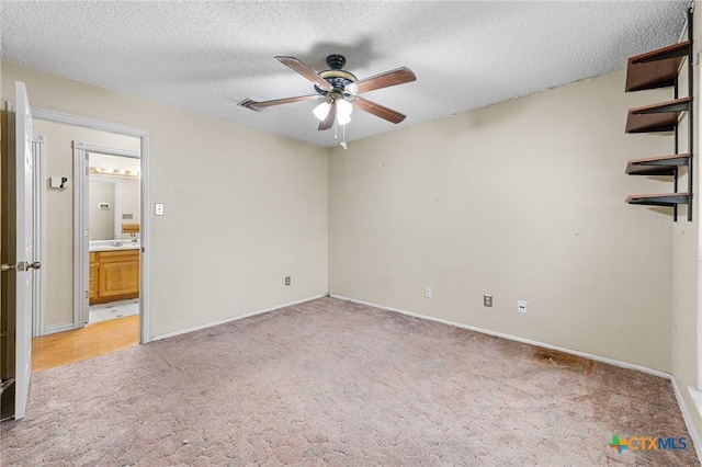 14311 Arrowood, San Antonio, TX 78233 - empty room featuring light carpet, a ceiling fan, and a textured ceiling