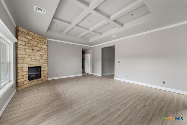 unfurnished living room with baseboards, coffered ceiling, beam ceiling, and visible vents