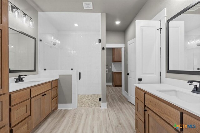 101 Dana Point Rd, Lorena, TX 76655 - full bath featuring a stall shower, two vanities, wood finished floors, and recessed lighting