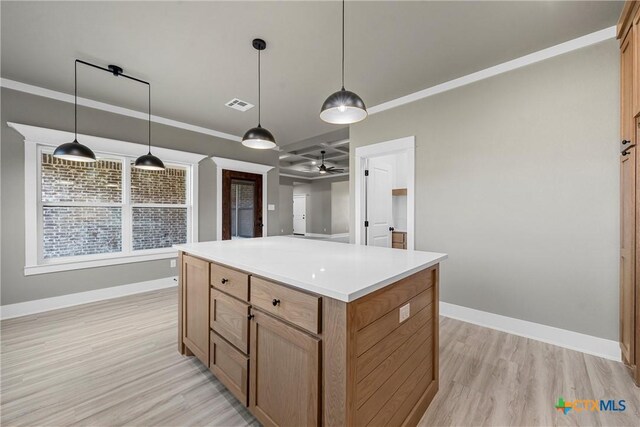 101 Dana Point Rd, Lorena, TX 76655 - kitchen with light wood-style floors, baseboards, a kitchen island, decorative light fixtures, and light countertops