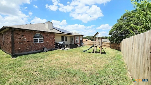 501 Mesquite Cir, Copperas Cove, TX 76522 - back of property with a fenced backyard, a patio area, brick siding, a playground, and a chimney