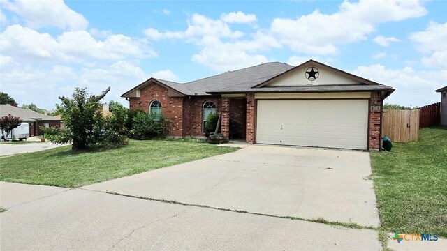 501 Mesquite Cir, Copperas Cove, TX 76522 - ranch-style home with brick siding, an attached garage, and driveway