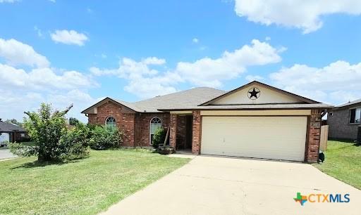 501 Mesquite Cir, Copperas Cove, TX 76522 - single story home featuring brick siding, driveway, a garage, and a front yard